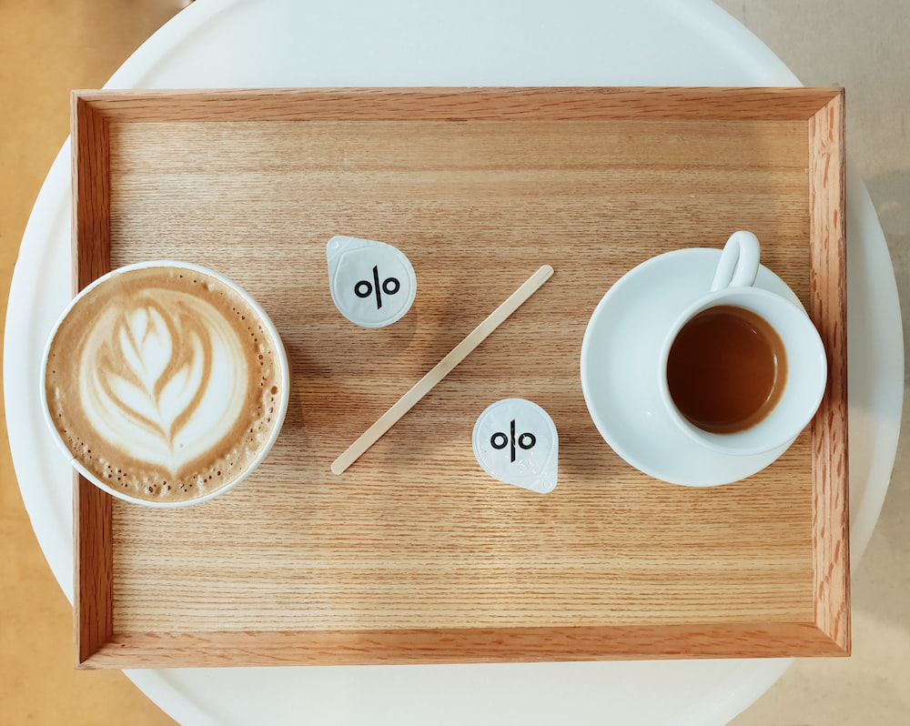 coffee in ceramic and paper cup on a tray