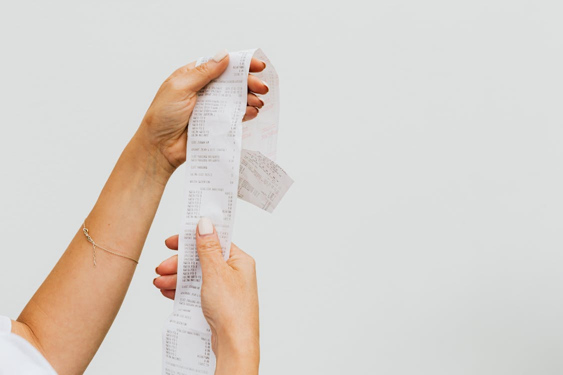 A woman is holding a receipt