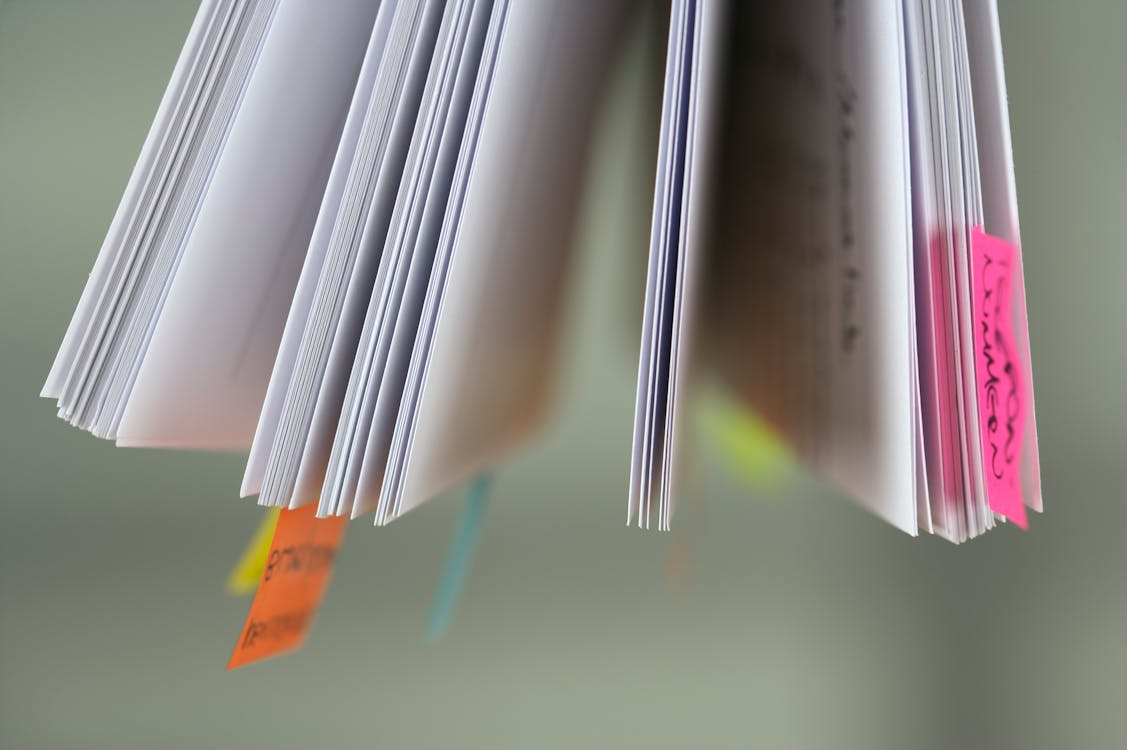 An image of multiple documents with colorful bookmarks.